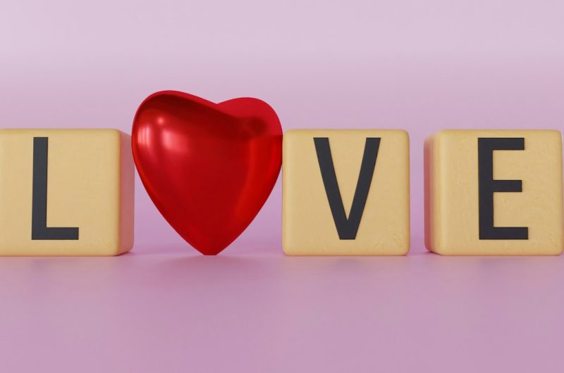 a wooden block spelling love with a red heart