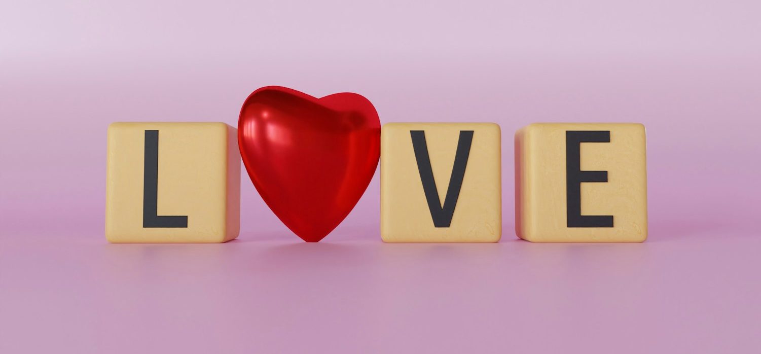 a wooden block spelling love with a red heart